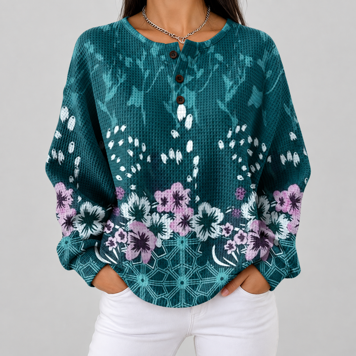 Yolande – Türkise Pulli mit Blüemli