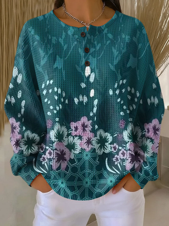 Yolande – Türkise Pulli mit Blüemli